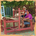 Woman working on the loom on street in Sapanta
